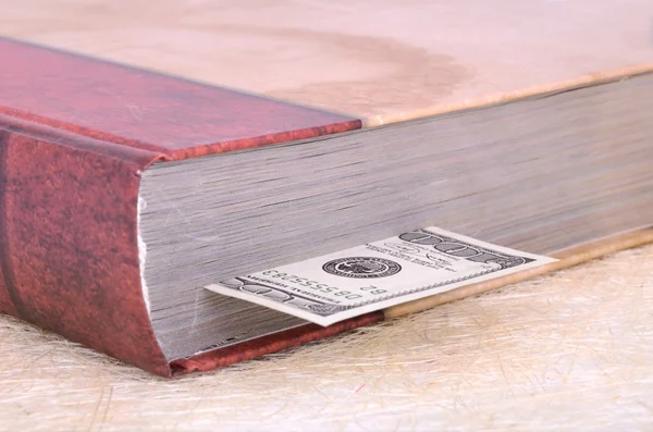 Closed brown book with a bookmark 100 USD — Stock Photo, Image