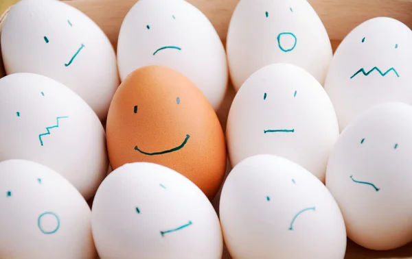 White and one brown smile eggs in tray horizontal — Stock Photo, Image