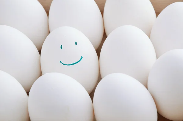 White and one smile eggs in tray horizontal — Stock Photo, Image