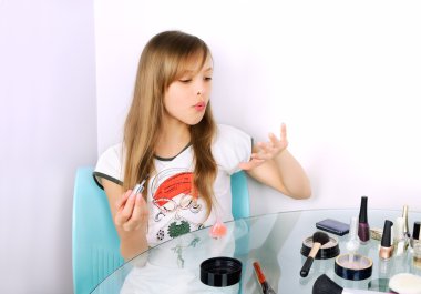 teenager girl blowing on painted nails horizontal clipart
