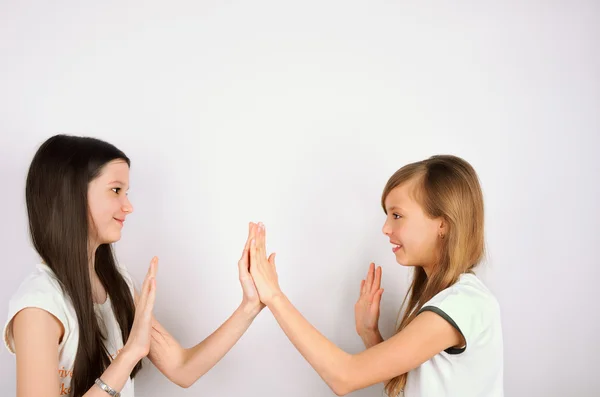 Two girls claping palms — Stock Photo, Image