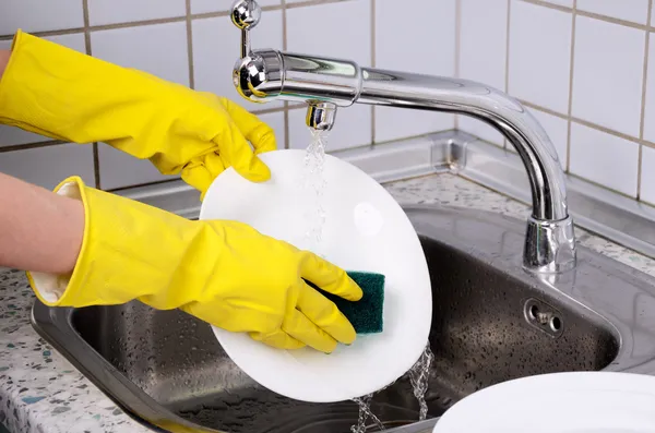 Womans hands in the gloves wash plate horizontal 0903 — Stock Photo, Image