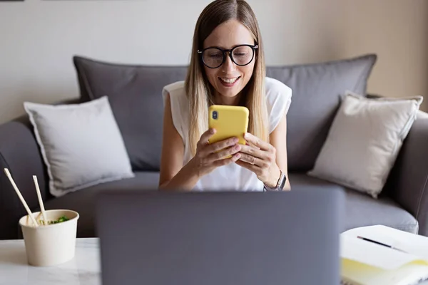 Work from home during coronavirus quarantine. Business Woman using laptop on kitchen. Freelancer talks to colleagues online at video chat. Stay at home during covid-19 concept