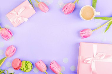 View from above tulips and gift box with copy space on violet background. Mockup for womens day, 8 March Valentines day, 14 february. Flat lay style, top view, template, overhead. Greeting card