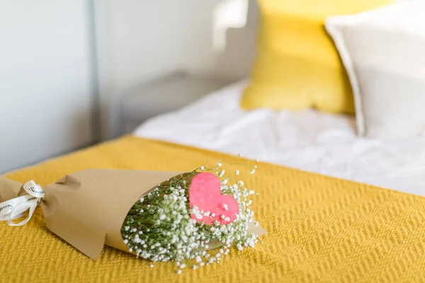 Buquê de flores de gypsophila branco deitado na cama com xadrez de malha amarela no quarto. Feliz Dia dos Namorados, Dia das Mães, Presente de aniversário. Belo fundo. Foco seletivo. Espaço de cópia — Fotografia de Stock