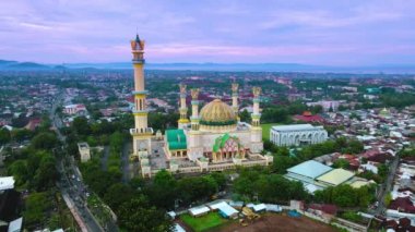 Yellow Mosque (Habbul Wathan Mosque) in Indonesia, Aerial drone view Mosque Sunny day, blue sky, sunset. Indonesia part of the city, downtown, beautiful mosque in the world
