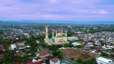 Yellow Mosque (Habbul Wathan Mosque) in Indonesia, Aerial drone view Mosque Sunny day, blue sky, sunset. Indonesia part of the city, downtown, beautiful mosque in the world