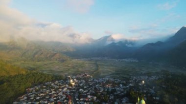 aerial view of the village and misty rice fields, surrounded by hills in the afternoon, location in the village of sembalun lombok