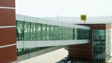 Telescopic gangway, sleeve, aerobridge in plane in airport. passengers boarding plane to flight on aircraft in departure gate terminal in airport, Slow motion, 4k