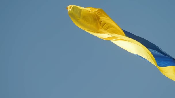 Ukrainian Flag Waving Against Blue Sky. Blue-Yellow Official State Symbol of Ukraine. National Sign slow motion — Wideo stockowe