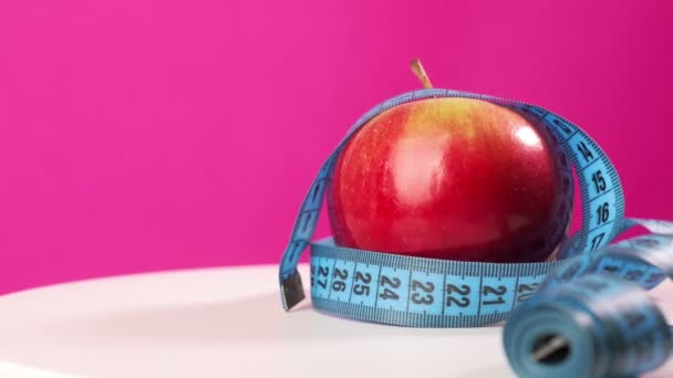 Apple Pink Background Wrapped Centimeter Tape — Stock Video