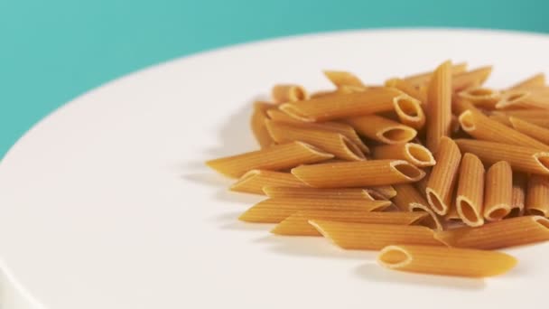 Whole Grain Durum Wheat Pasta Lies White Table Rotates Blue — Stockvideo