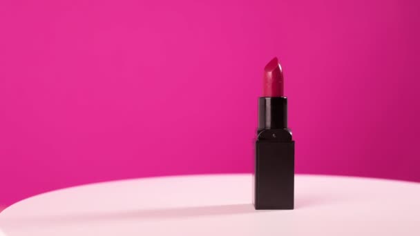 Lipstick Black Case Rotates Pink Background Beauty Industry Concept — Video Stock