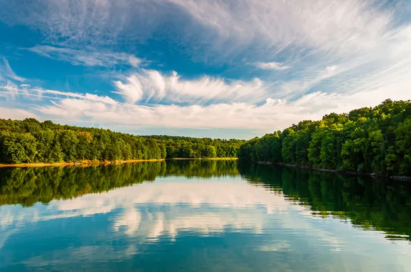 Kvällen reflektioner av moln och träd i sjön marburg, codorus — Stockfoto