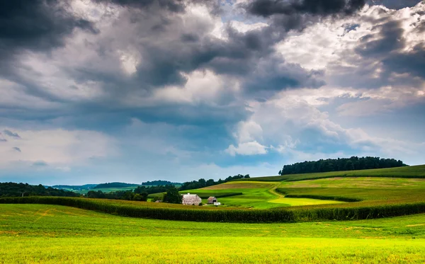 Storm clouds over rolling hills and farm fields in Southern York