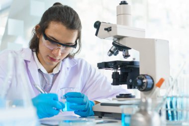 Laboratuvar araştırma konsepti, laboratuvarda çalışan ve belge üzerinde deney yapan bilim adamı..