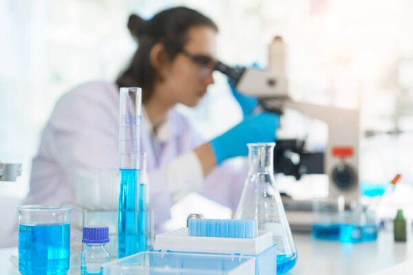 Laboratory research concept, Scientist using microscope to research and development of vaccine.