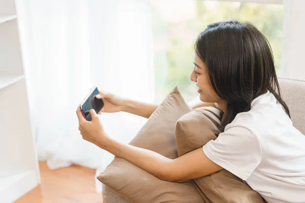 Home Lifestyle Concept Young Woman Sitting Couch Playing Games Smartphone — Stock Photo, Image