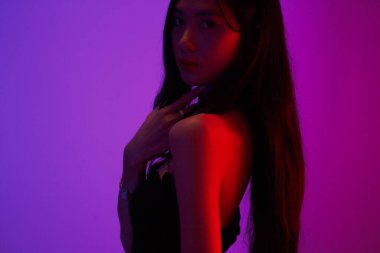Fashion and beauty concept, Fashion woman is posing with jewelry on neon light background.