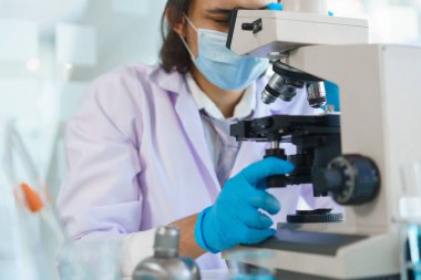 Laboratuvar araştırma konsepti, laboratuvarda mikroskopla ilaç ve aşı araştırması yapan bilim adamı..