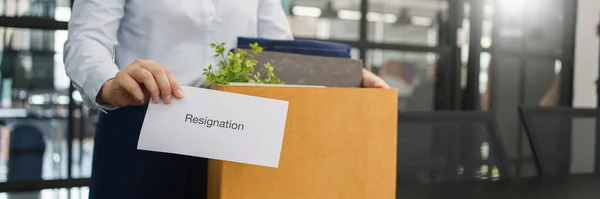 Concept of leaving job, Female employee holding stuff box and sending resignation letter to boss.