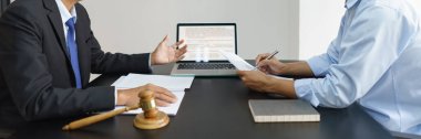 Lawyer and justice concept, Businessman takes notes as senior lawyer explain detail of the contract.