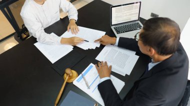 Lawyer and legal concept, Senior lawyer pointing to contract while explaining detail to businessman.