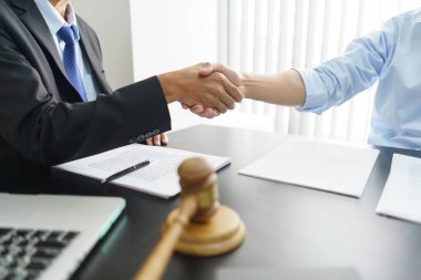Lawyer and legal concept, Businessman and senior lawyer shake hands after successful deal contract.
