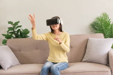Leisure activities concept, Young woman touching the air to experience the virtual with glasses VR.