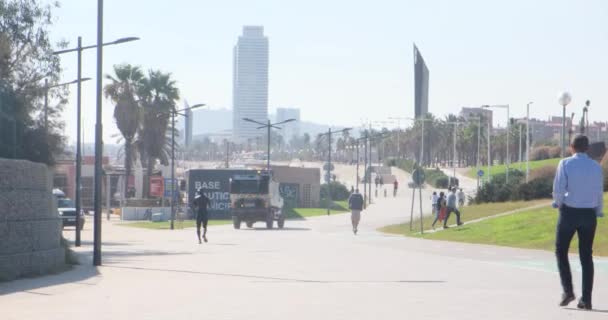 Barcelona, Španělsko - 2. listopadu 2021: Barcelonské město, lidová aktivita v Barceloně: procházky, sportovní aktivity a stěhování za slunečného dne. Auta, palmy a mrakodrap, Illustrative Editorial — Stock video