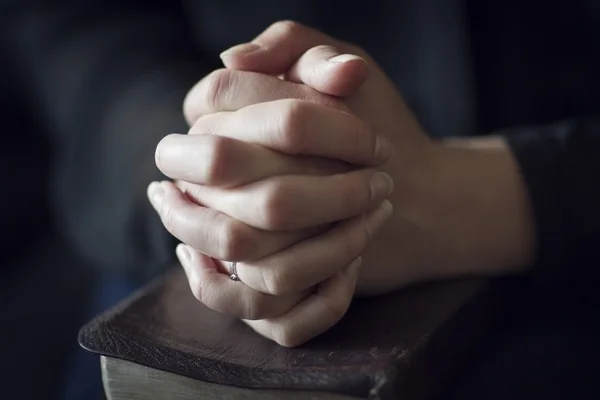 Folding Hands over a Bible — Stock Photo, Image