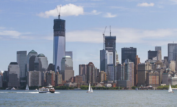 Manhatten shot from Liberty Island on day time in July. One World Trade Center under construction.