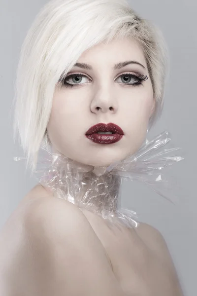 Blonde young woman model in plastic — Stock Photo, Image