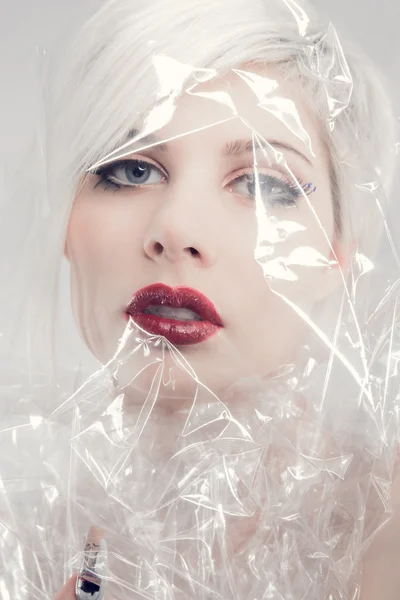 Blonde woman model wrapped in plastic — Stock Photo, Image