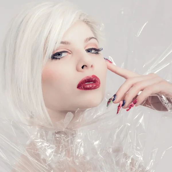 Posing blonde fashion model in plastic — Stock Photo, Image