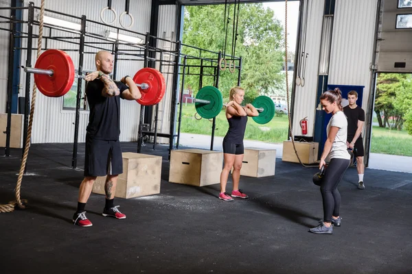 Crossfit training with weights and kettlebells — Stock Photo, Image