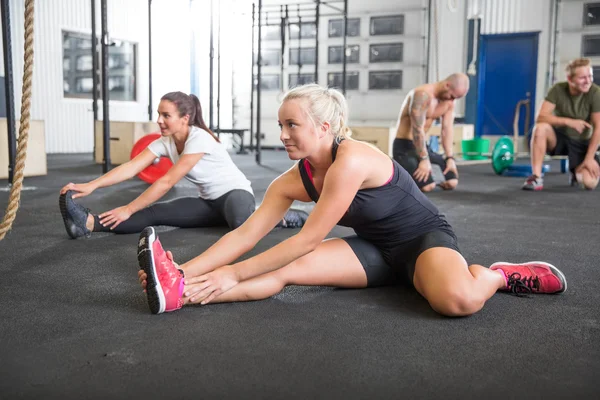 Two women stretching on the floor — Stock Photo, Image