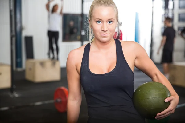 Fitness woman with slam ball at gym center — Stock Photo, Image