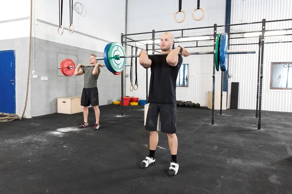 Clean and jerk workout at fitness gym center — Stock Photo, Image