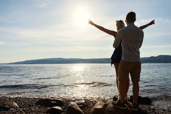 Man Standing Behind And Holding Girlfriend With Arms Outstretched — Photo