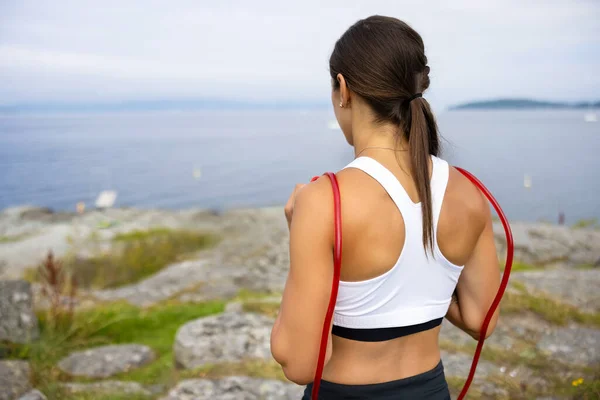 Rear View Female Looking Sea Mountain While Exercising Jump Rope — Stock Fotó