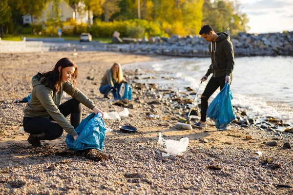 Woman Team Picking Garbage Bag Beach Volunteers Cleaning Rocky Shore Obrazy Stockowe bez tantiem