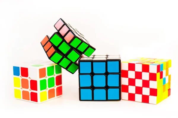 Four Rubik Cubes Interesting Puzzles Development Intelligence White Background Horizontal — Zdjęcie stockowe