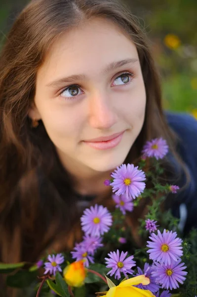 Teen Girl Sits Next Flowers Bloom Violet Flowers Dreamingly Looks — Fotografia de Stock