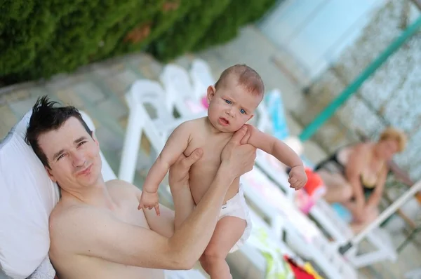 Man Lays Lounger Holds Hands His Little Son Summer Together — стоковое фото