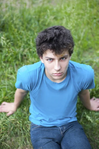 Sad Boy Adolescence Angry Face Sitting Grass Park Looking Vertical —  Fotos de Stock