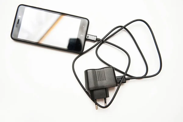 Black Smartphone Comfortable Charger White Background Copy Space — Stockfoto