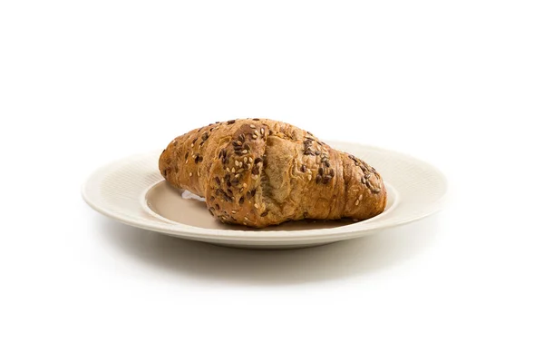 One croissant on an off-white plate — Stock Photo, Image