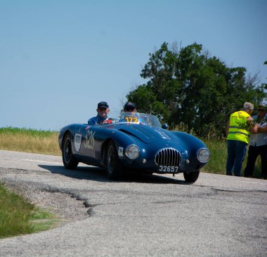 URBINO - ITALY - JUN 16 - 2022 : RAYMOND NIESEN L O.S.C.A. MT4 1350 2AD 1955 on an old racing car in rally Mille Miglia 2022 the famous italian historical race (1927-1957