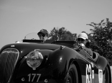 URBINO - ITALY - JUN 16 - 2022 : JAGUAR XK120 OTS ROADSTER 1950 on an old racing car in rally Mille Miglia 2022 the famous italian historical race (1927-1957